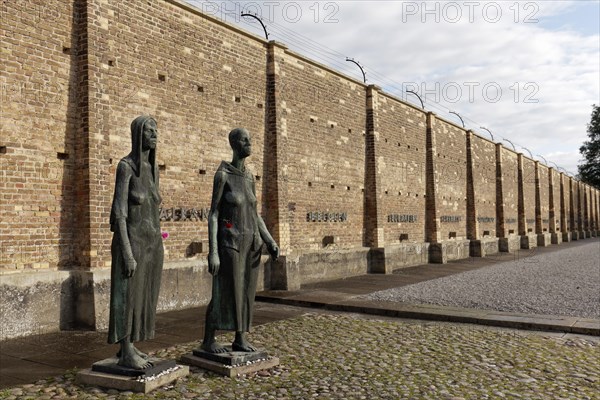 Sculptures of women in front of the Wall of Nations