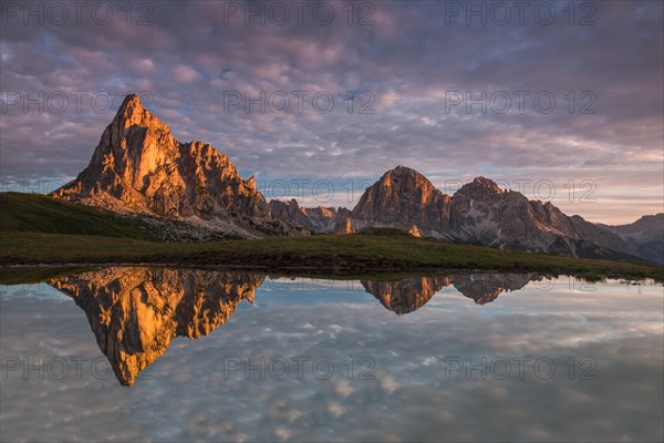 Gusela mountain at sunrise reflected in small lake