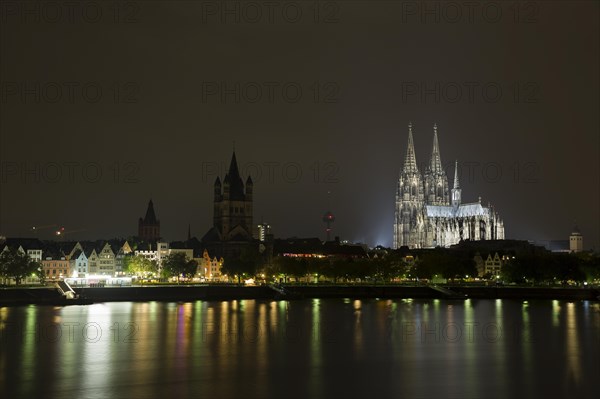 The Cologne Cathedral illuminated at night with Rhine