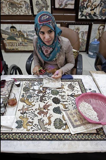 Woman working on replica of the famous mosaic of the Byzantine Franciscan Monastery Church