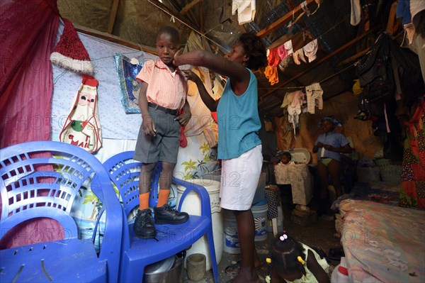 Woman dressing her son