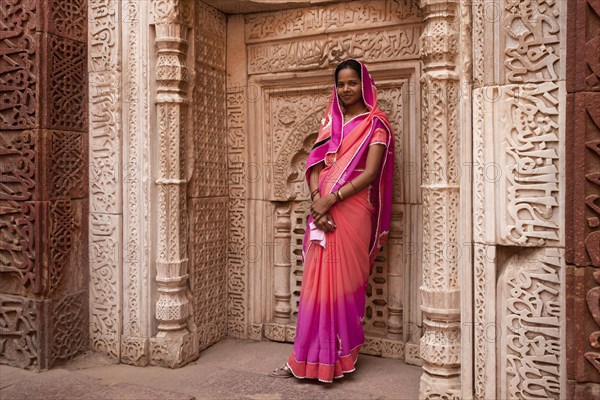 Young Indian woman posing in the Qutub Minar Complex or Qutb Complex