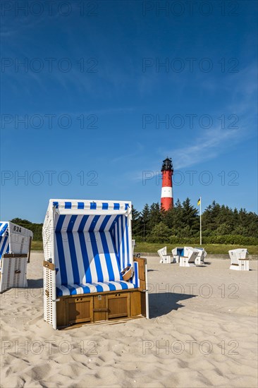 Beach chair on the beach in front of the lighthouse