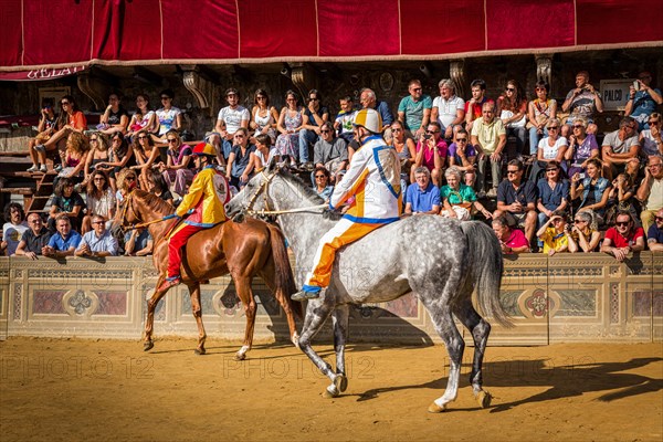 Jockeys waiting for the start of Palio di Siena horse race on Piazza del Campo