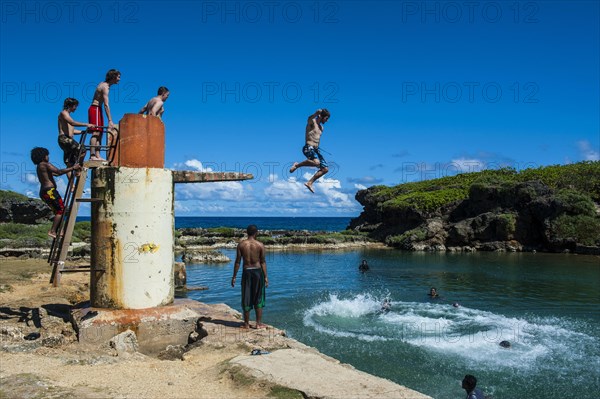 Local boys jumping and swimming in the Salugula Pool