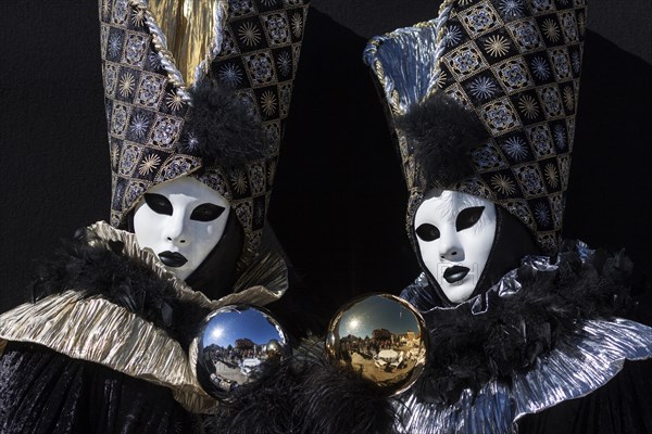 Venetian Carnival masks and costumes at the Venetian Fair on the historic market square