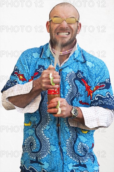 Man holding squirting soda bottle