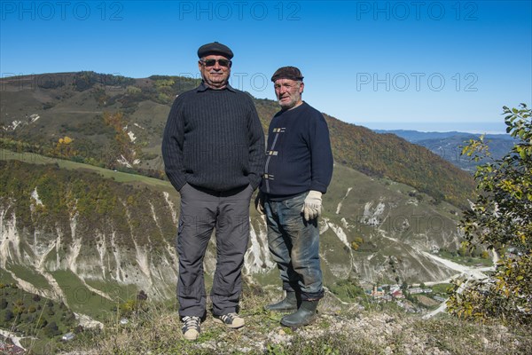 Old Chechen men at an overlook in the Chechen mountains