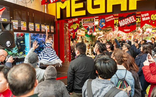 Karaoke singer in front of an audience in front of the shopping mall Mega Don Quijote-Shibuya