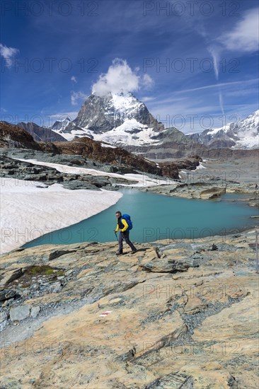 Hiker at glacier lake on the way to the Gandegg hut