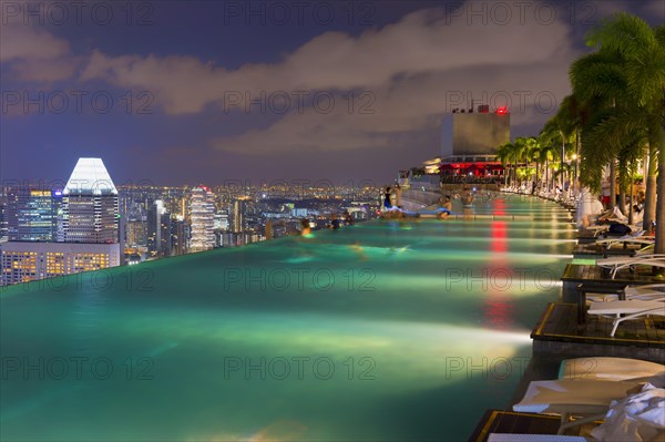 Downtown central financial district at night viewed from the Infinity pool of the Marina Bay Sands