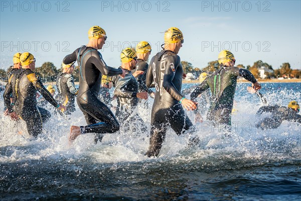 Participants of the Ironman Triathlon starting the race in the surf