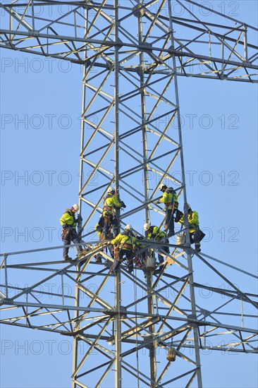 Overhead linemen working on a pylon