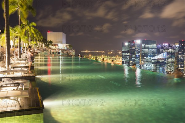 Downtown central financial district at night viewed from the Infinity pool of the Marina Bay Sands