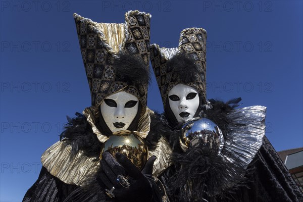 Venetian Carnival masks and costumes at the Venetian Fair on the historic market square