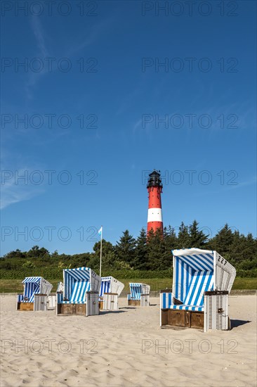 Beach chairs on the beach in front of the lighthouse