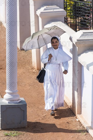 Smiling nun with parasol