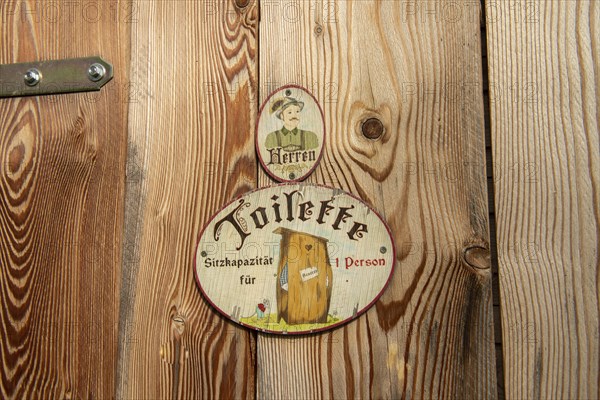Sign toilet men at wooden door