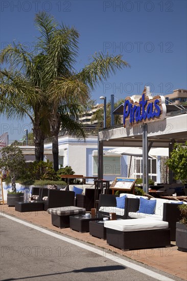 Restaurant and palm trees on the promenade