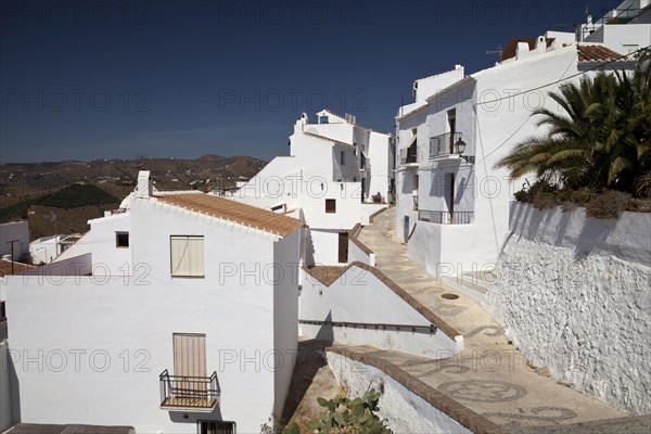 White houses in a narrow alley in Frigiliana