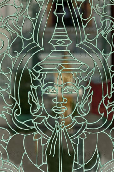 Metal mesh gate with a representation of Buddha in the Royal Palace