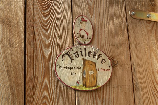 Sign toilet men at wooden door