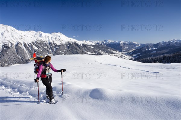 Snowshoe hiker during the ascent to Jagelealm alpine pasture