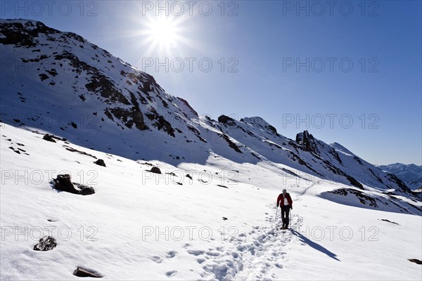 Mountain climber ascending Wilde Kreuzspitze Mountain in the Pfunderer Mountains
