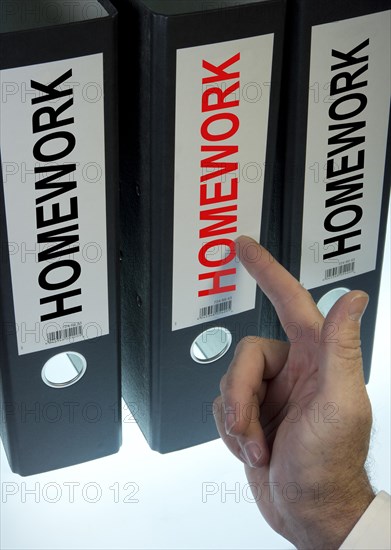 Hand pointing to a file folder labeled 'Homework'