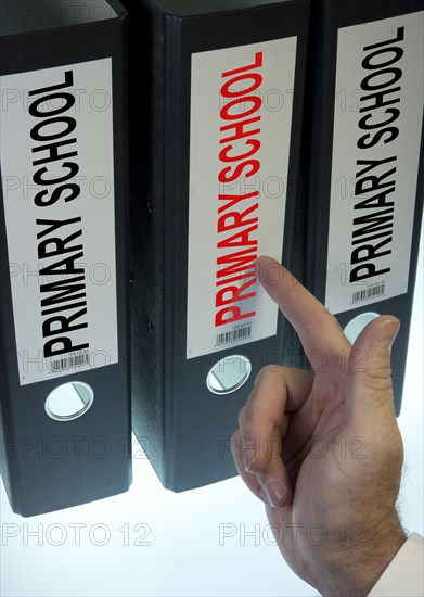 Hand pointing to a file folder labeled 'Primary School'