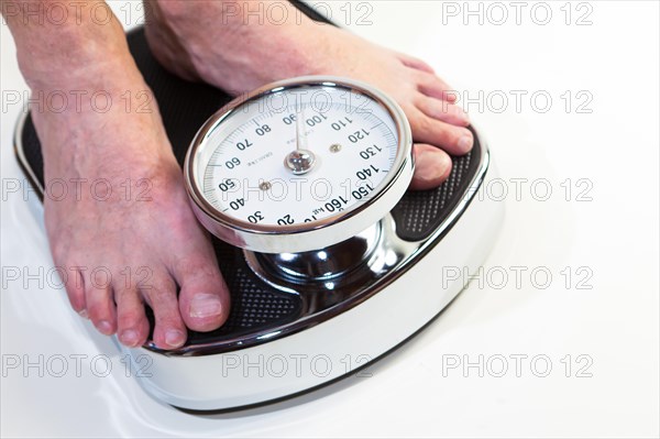 A man standing on bathroom scales