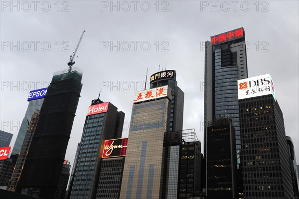 Skyscrapers and neon signs at dusk