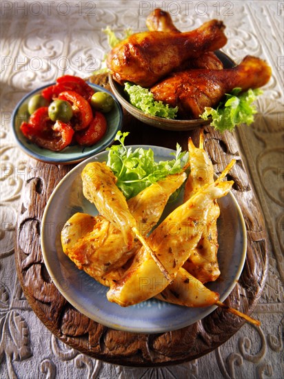 Party buffet food with chicken satay and BBQ drum sticks