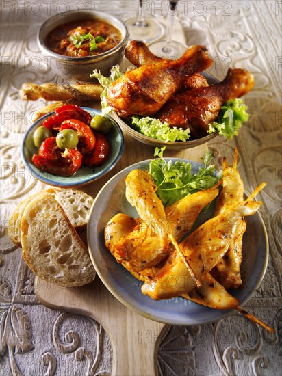 Party buffet food with chicken satay and BBQ drum sticks