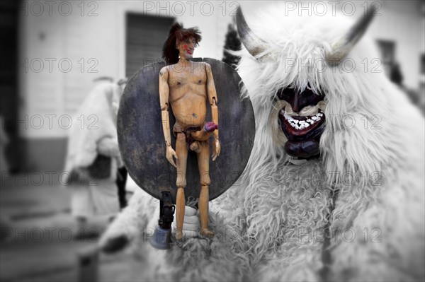 Buso with fertility figure on the Tuesday procession of the Busojaras Spring festival 2010