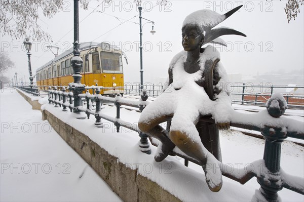 Bronze statue on the Danube Bank in the snow