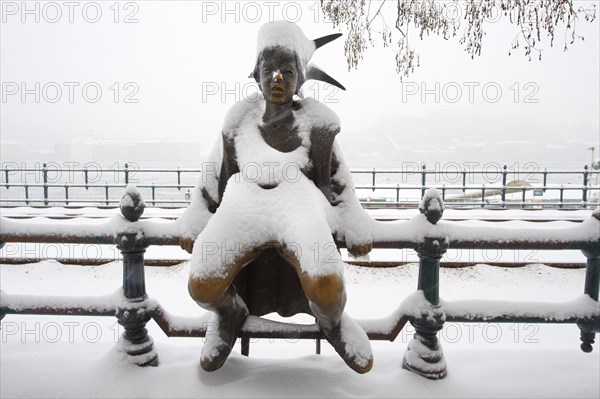 Bronze statue on the Danube Bank in the snow