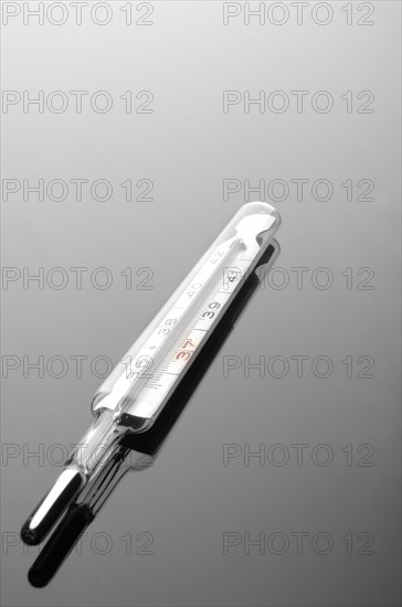 Mercury thermometer on a reflective surface