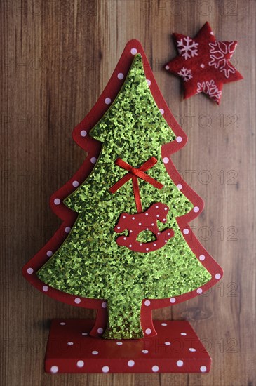 Miniature Christmas tree and a star on a wooden surface