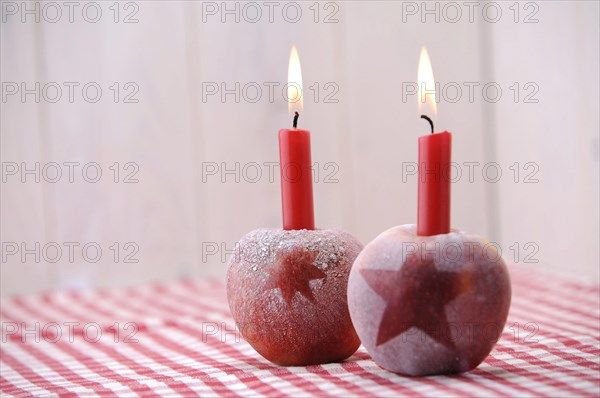 Christmas ambience with red apples and candles