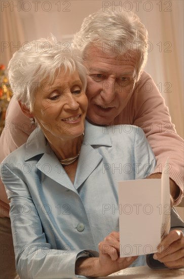 Mature couple reading Christmas cards