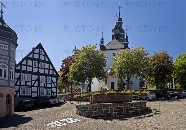 St. Peter's Fountain with the town coat of arms and the Church of St. Heribert in Hallenberg