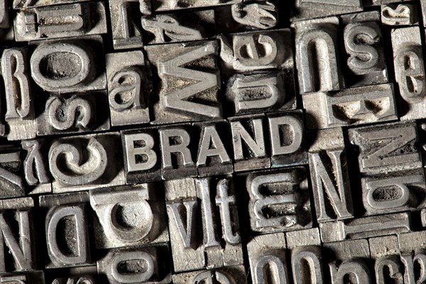 Old lead letters forming the word 'BRAND'