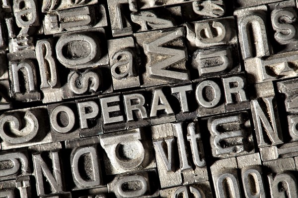 Old lead letters forming the word OPERATOR