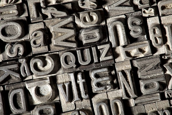 Old lead letters forming the word 'QUIZ'