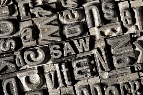 Old lead letters forming the word SAW