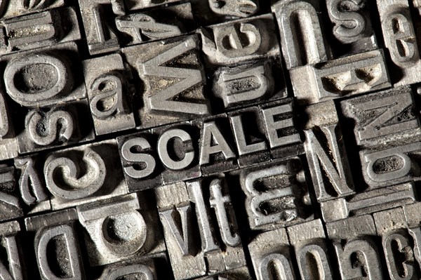 Old lead letters forming the word SCALE