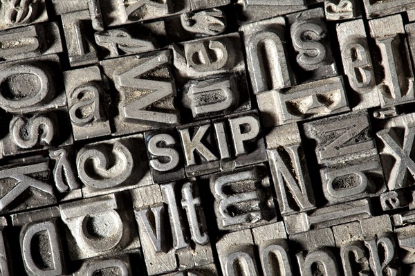 Old lead letters forming the word SKIP