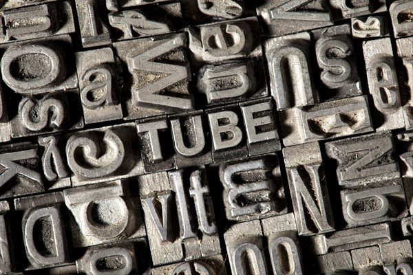 Old lead letters forming the word TUBE