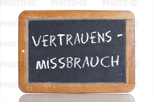 Old school blackboard with the term VERTRAUENSMISSBRAUCH